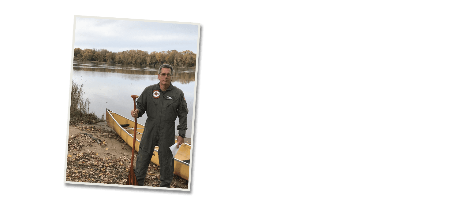 Jim Crigler by riverbank with canoe